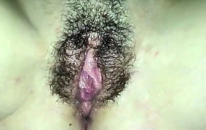 Taking care of her hairy pussy