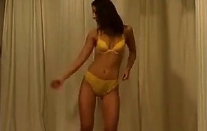 Sexy brunette babe at home stripteasing and seduci