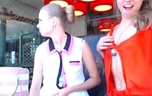 Two sweet teens flash in a cafe,...