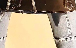 Blonde in jeans pees in wine glass 