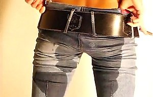 Blonde in jeans pees in wine glass 