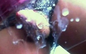 Blondie jerks off and eats her own cum from a glass sheet