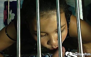 Caged beauty sucks a dick through the bars
