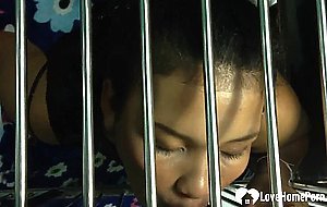 Caged beauty sucks a dick through the bars