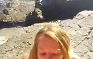 Bikini girl sucks cock on the rocky shore
