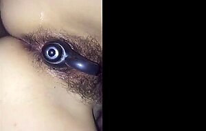 Hairy Japanese girl with a toy in her pussy