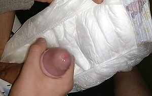 Twink cumming his wet diaper