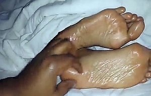 Oiled wifes foot filmed up close