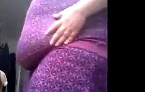 SSBBW in a purple dress plays with her giant belly