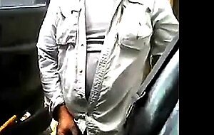 Bearded daddy strokes his cock by his truck outdoors.