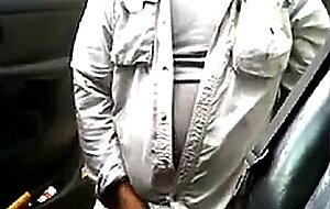 Bearded daddy strokes his cock by his truck outdoors.