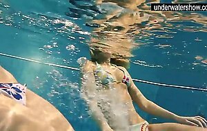 Two sexy amateurs showing their bodies off under water