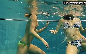 Two sexy amateurs showing their bodies off under water