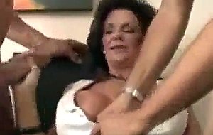 Busty milf takes two big cocks