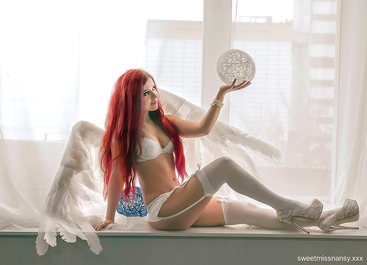 Redheaded angel Yummy Alice posing in her white lingerie in a cosplay solo