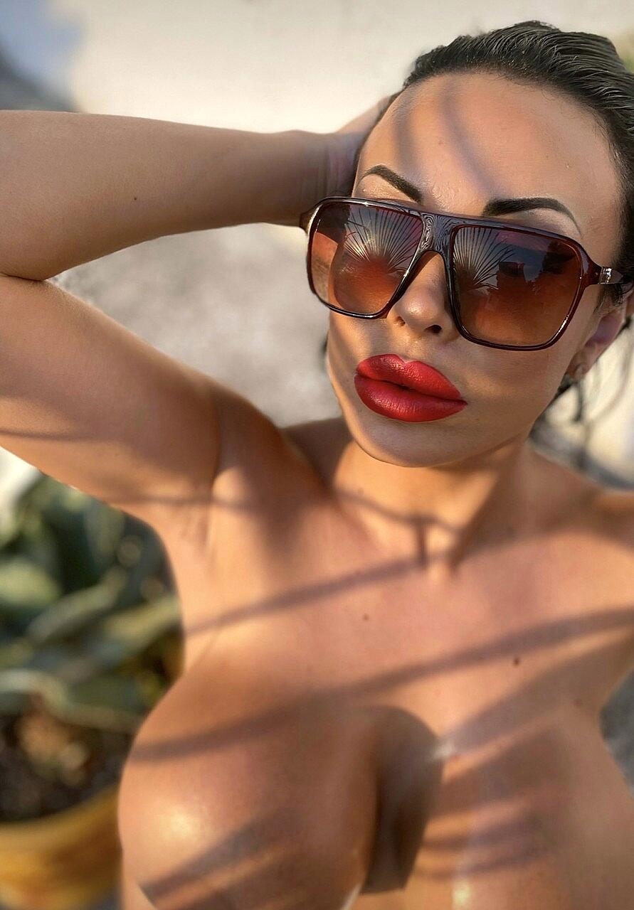 Glamorous OnlyFans babe Anastasia Doll rubs her huge oily boobs outdoors